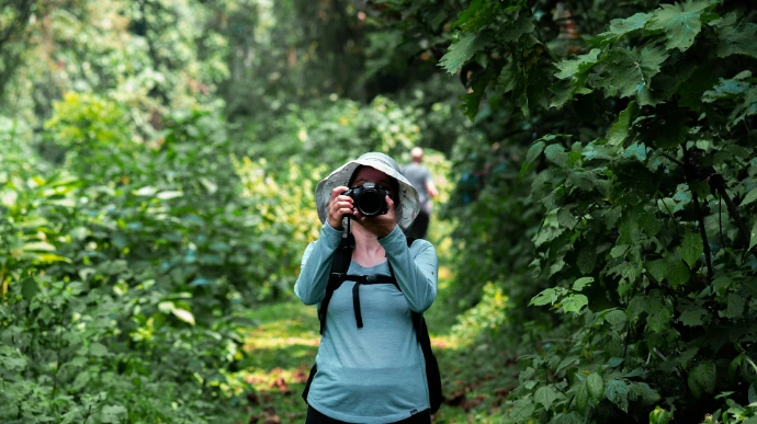 a woman taking a picture of herself in the woods a woman taking a picture of herself in the woods