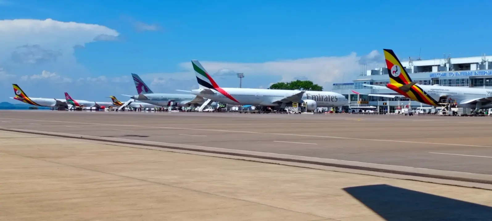 Entebbe International Airport - Things to do in Uganda A row of parked airplanes sitting on top of an airport tarmac