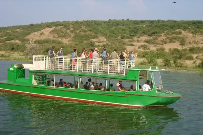 Tourists having a fun boat cruise in Queen Elizabeth National Park Kazinga channel boat cruise
